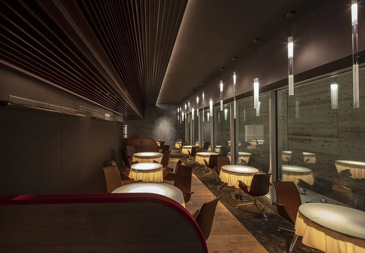 Elegant dining room at MUNI ALAIN DUCASSE in Kyoto with ambient lighting and decor.