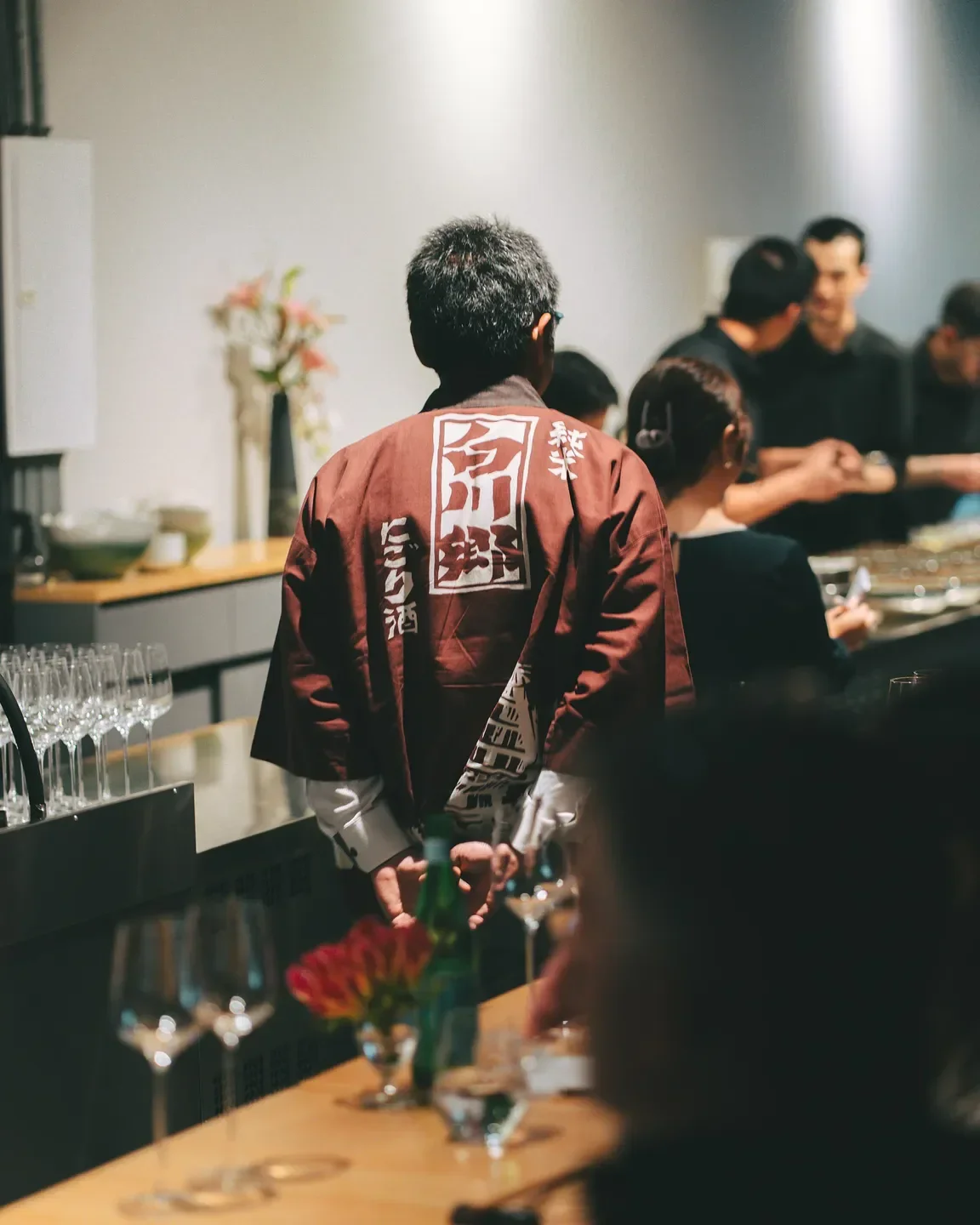 Inside Murakami restaurant in Sao Paulo: Chef wearing a jacket with Japanese script