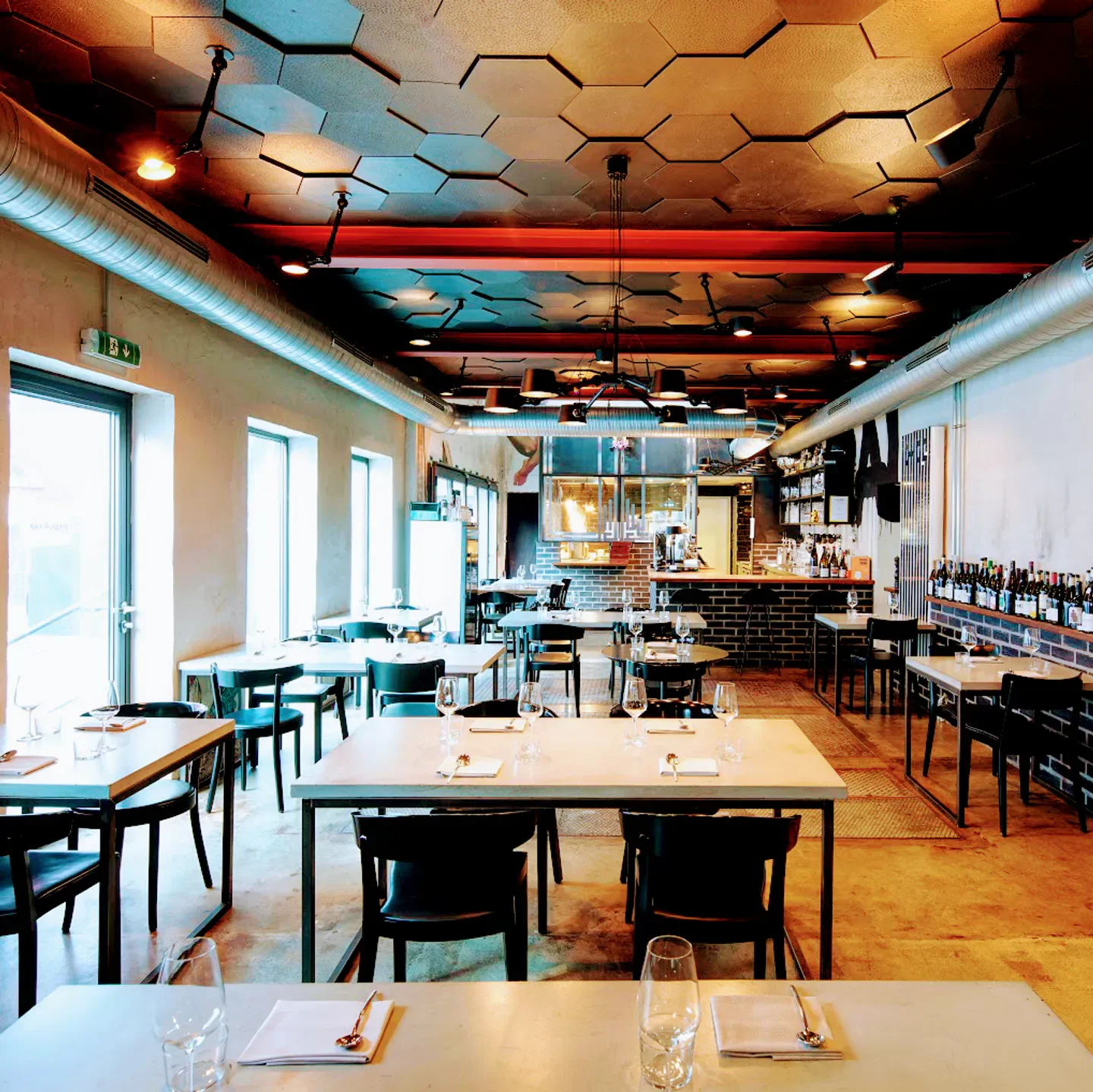 Interior of mural restaurant in Munich with stylish seating and unique ceiling design.