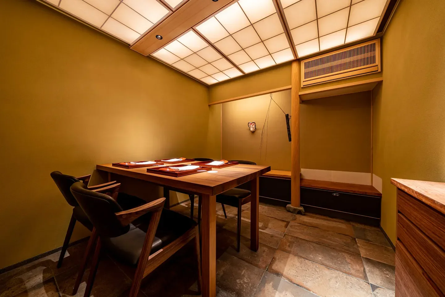 Cozy dining area at Muromachi Yui restaurant in Kyoto with elegant wooden details.