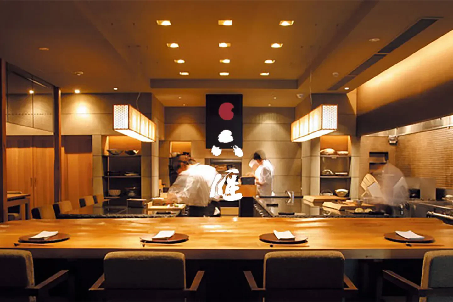 Interior of Mutsukari restaurant in Tokyo, featuring chefs at work and minimalist design