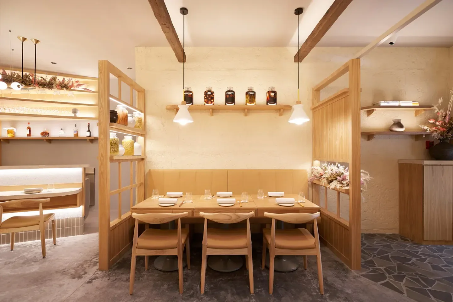 Cozy dining area at Nae:um restaurant in Singapore with elegant wooden furniture.