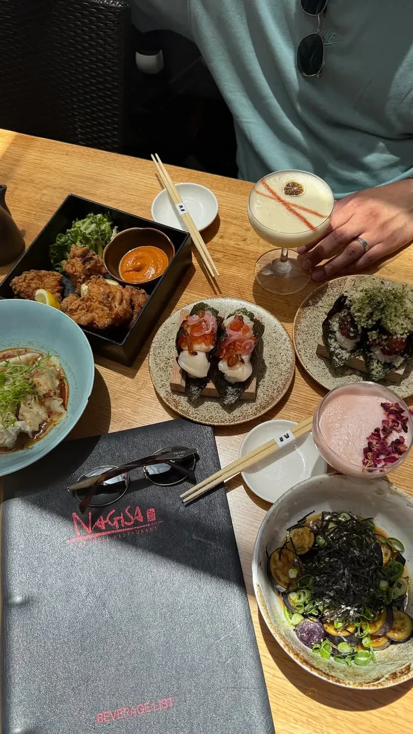 Delicious sushi and cocktails at NAGISA restaurant in Newcastle. Japanese food on table.