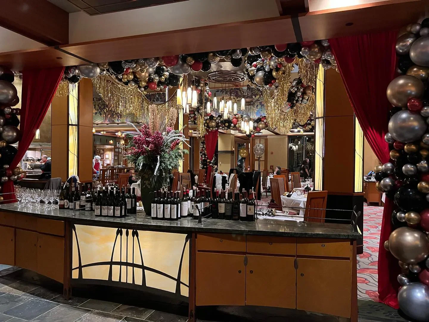 Interior of Napa Rose restaurant in Napa, with wine bottles and festive decor.