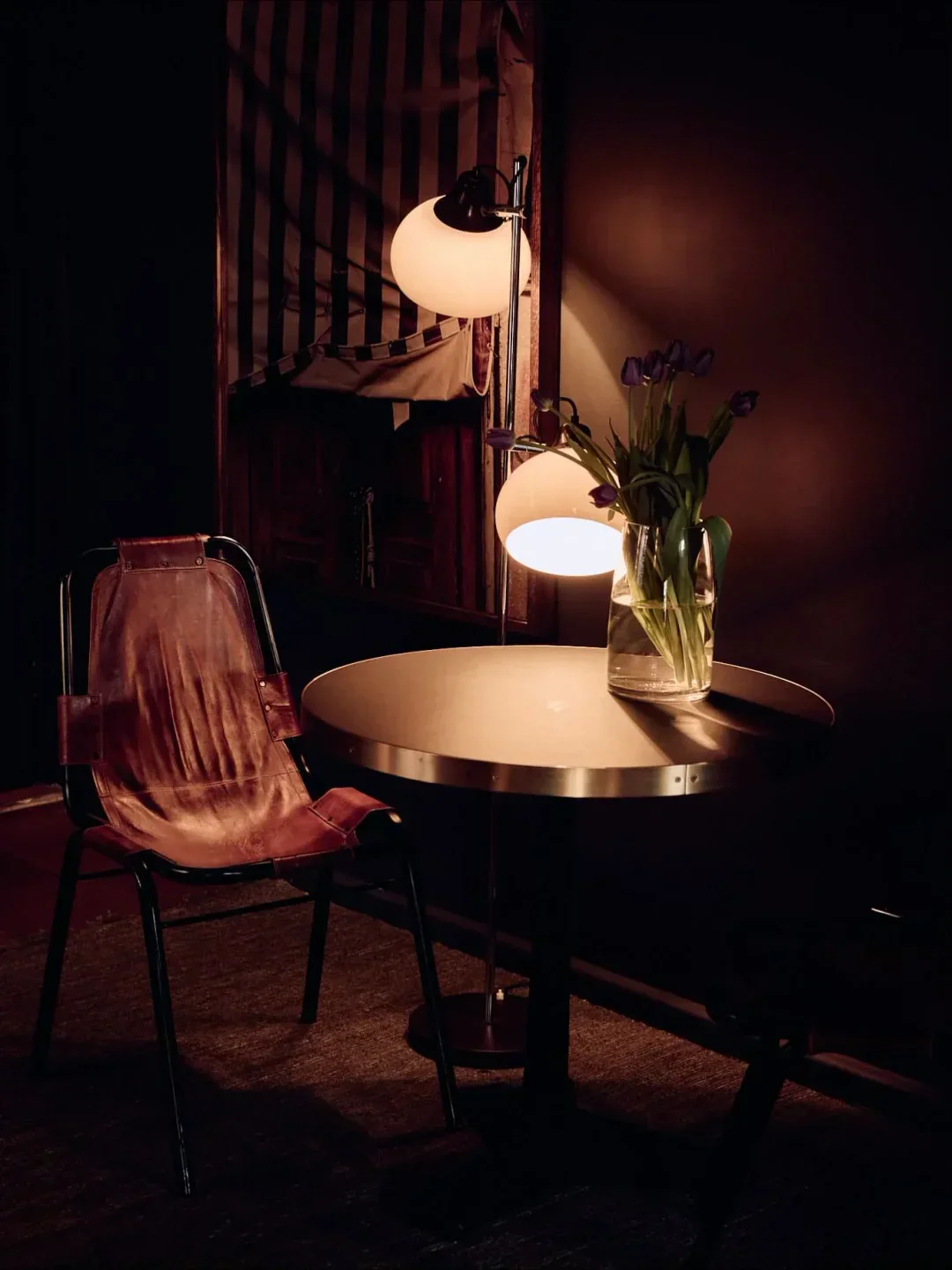 Cozy corner at Napier Quarter restaurant in Melbourne, with table, chair and floral arrangement.