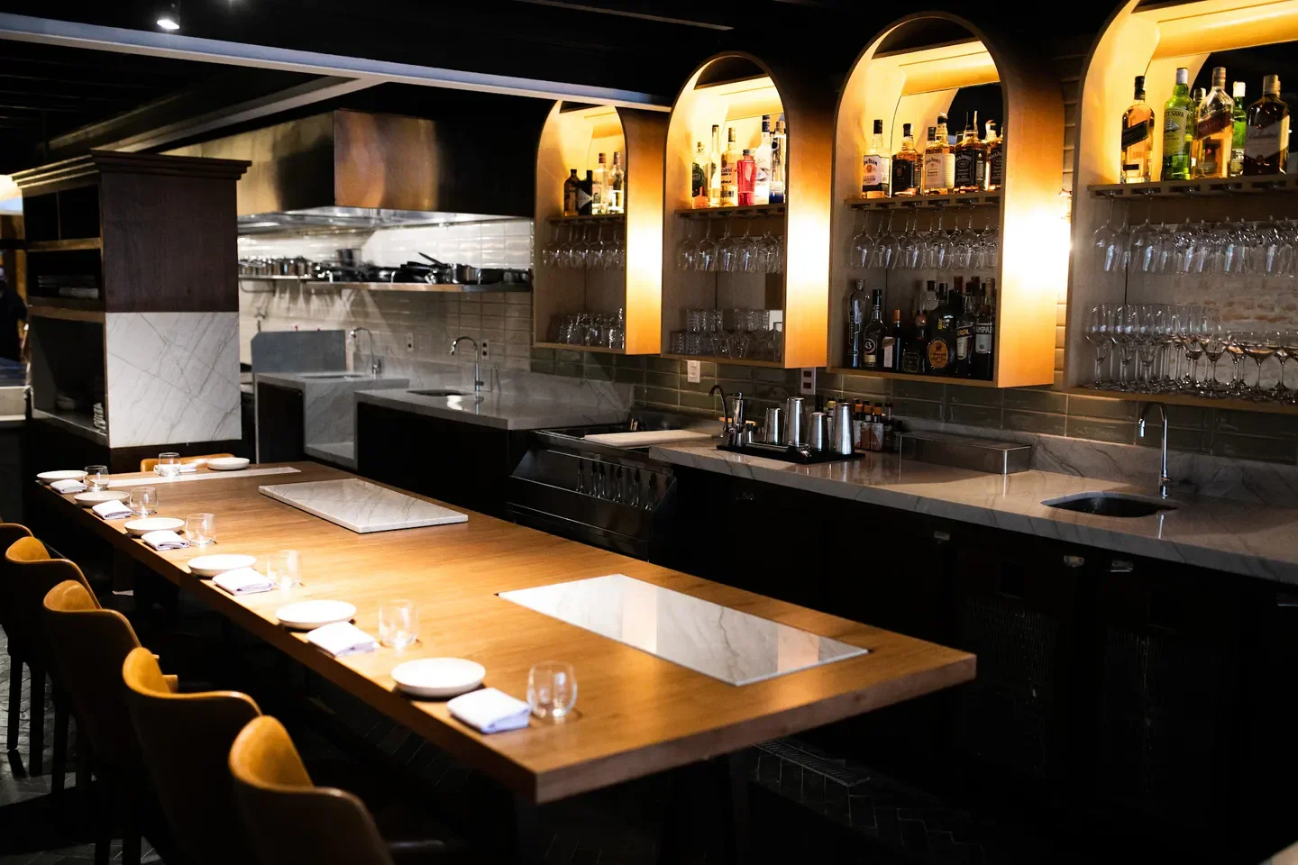 Interior view of Nelita restaurant in Sao Paulo with a wooden bar and elegant lighting.