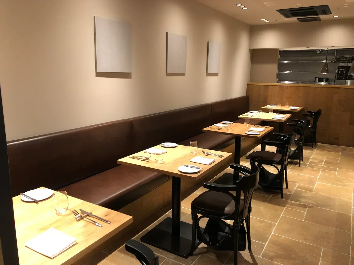 Interior view of nent restaurant in Osaka with tables, chairs, and minimalist decor.