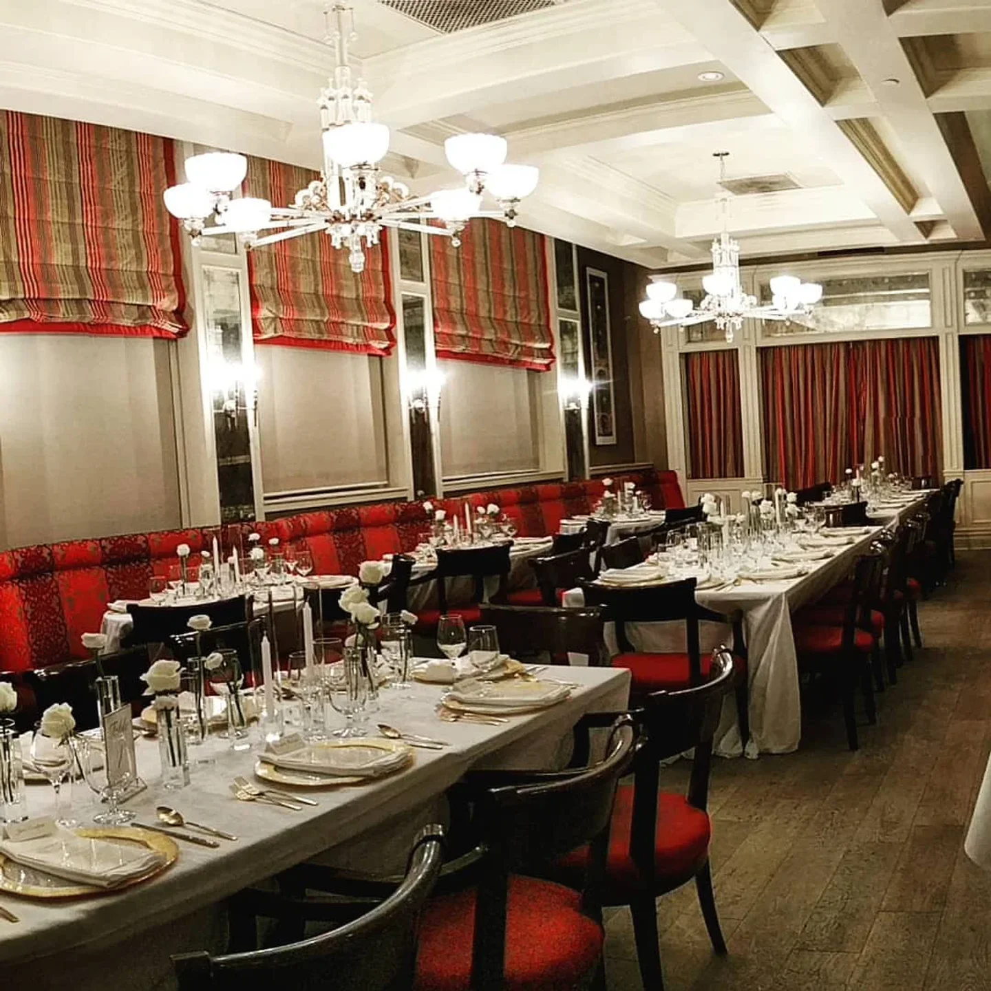 Interior dining room at New Sheridan Chop House in Telluride with elegant table settings and chandeliers.
