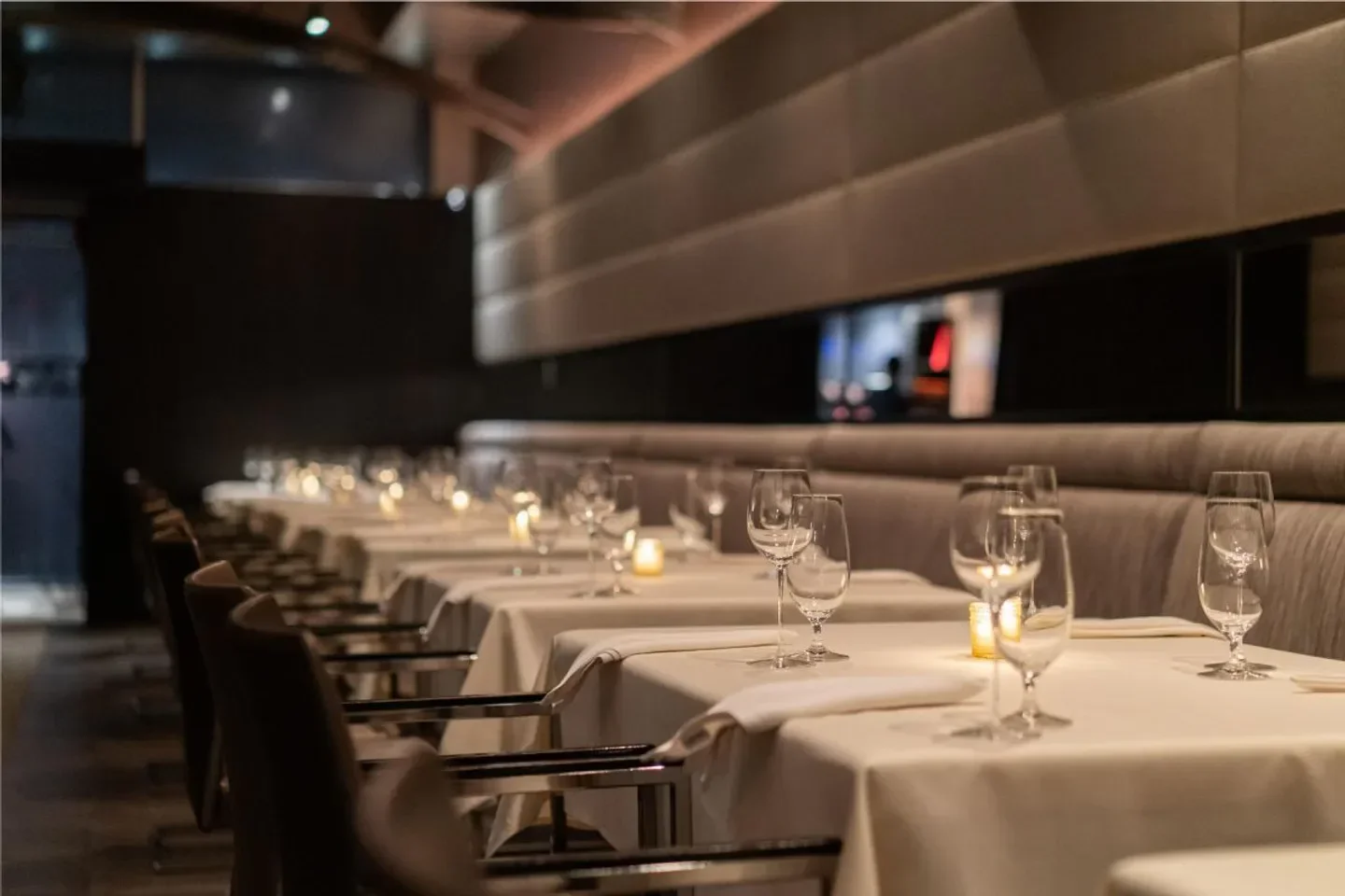 Elegant dining at Next Chicago restaurant with tables set for guests and candlelight.