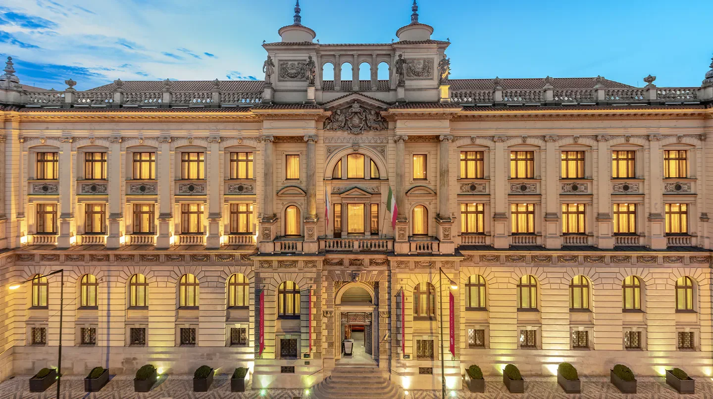 NH Collection Prague Carlo IV hotel exterior in Prague, illuminated at dusk.