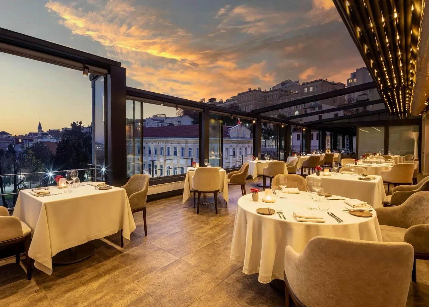 Elegant dining at Nicole restaurant in Istanbul with city views at sunset