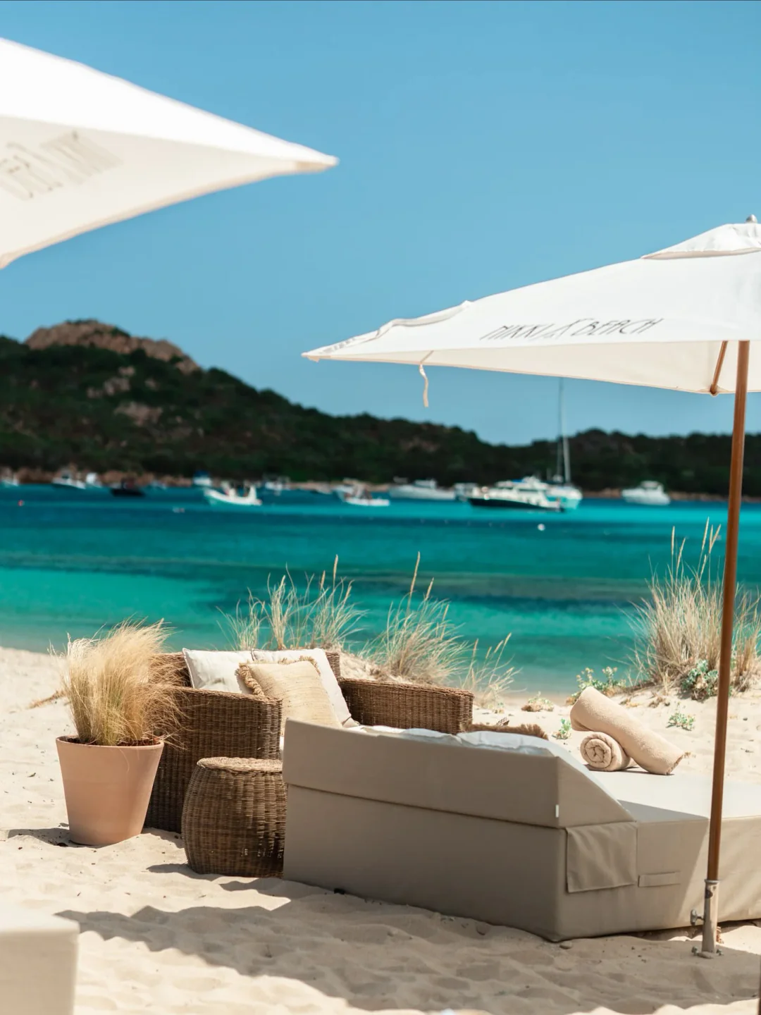Nikki Beach Costa Smeralda beach lounge area in Porto Cervo with turquoise water and yachts.