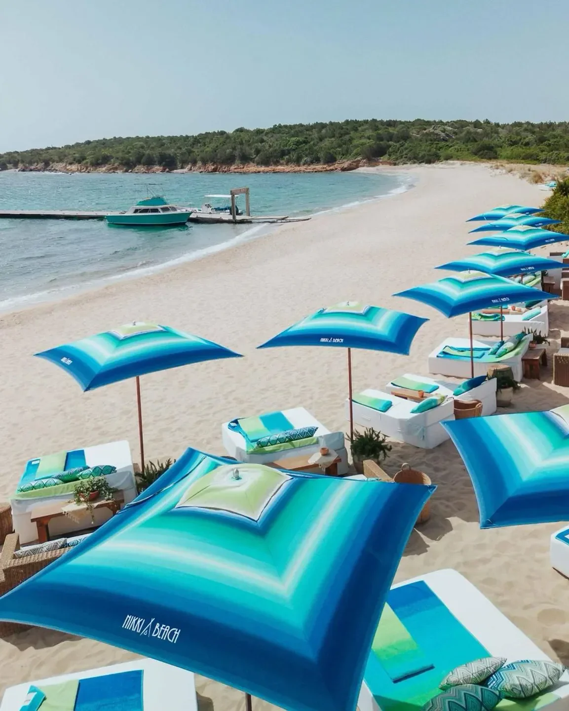 Beachfront at Nikki Beach Porto Cervo: lounge chairs and parasols on the sandy beach.