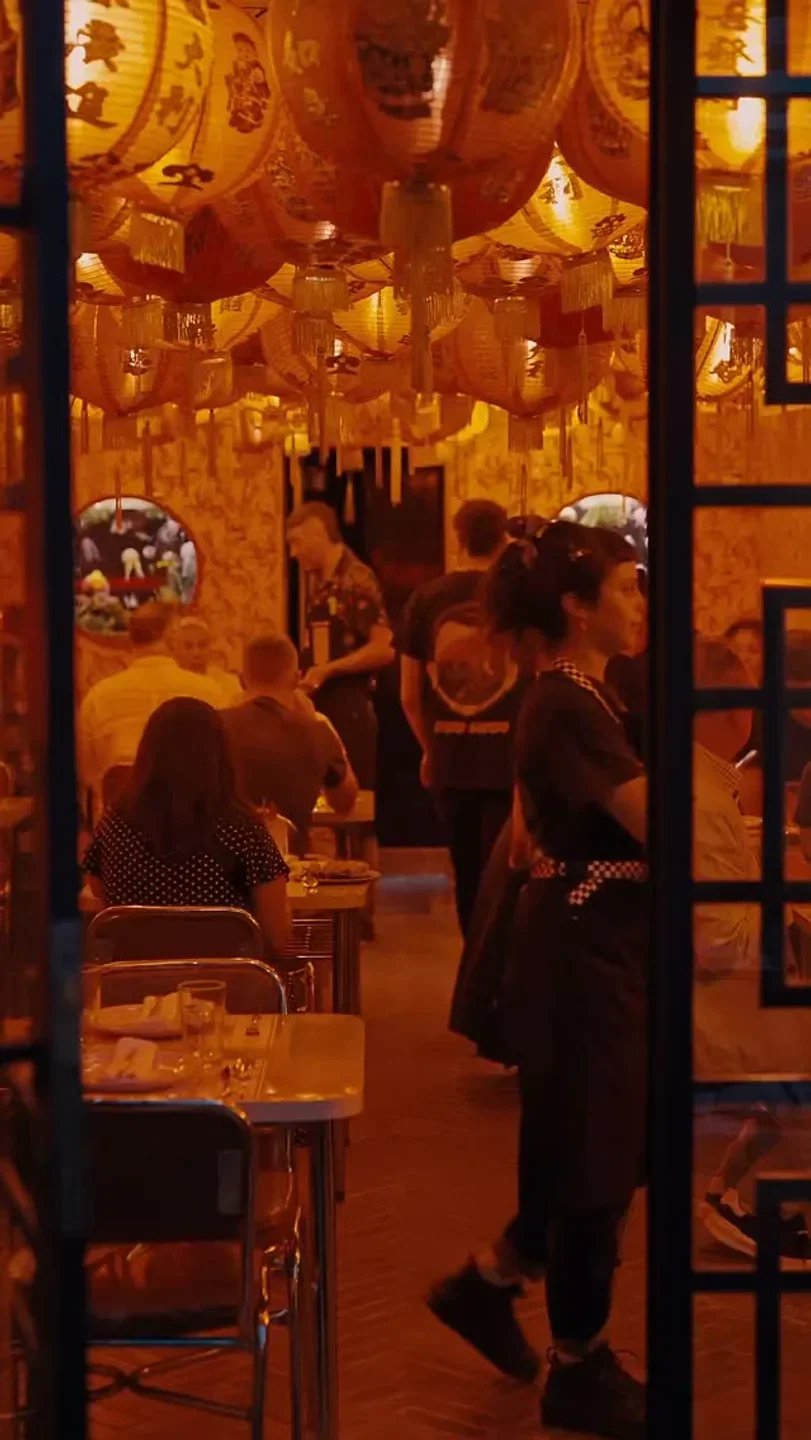 Interior of Niño Gordo restaurant in Buenos Aires, featuring Chinese lanterns and dining guests