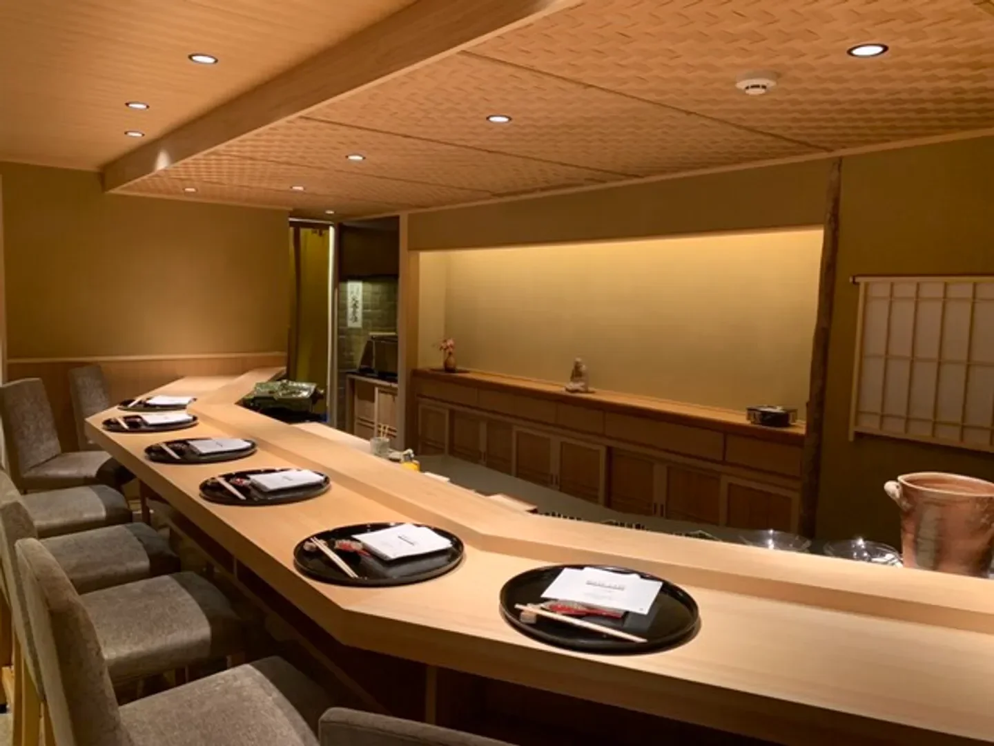 Interior of Nishiazabu Noguchi in Tokyo, featuring sushi bar with place settings.