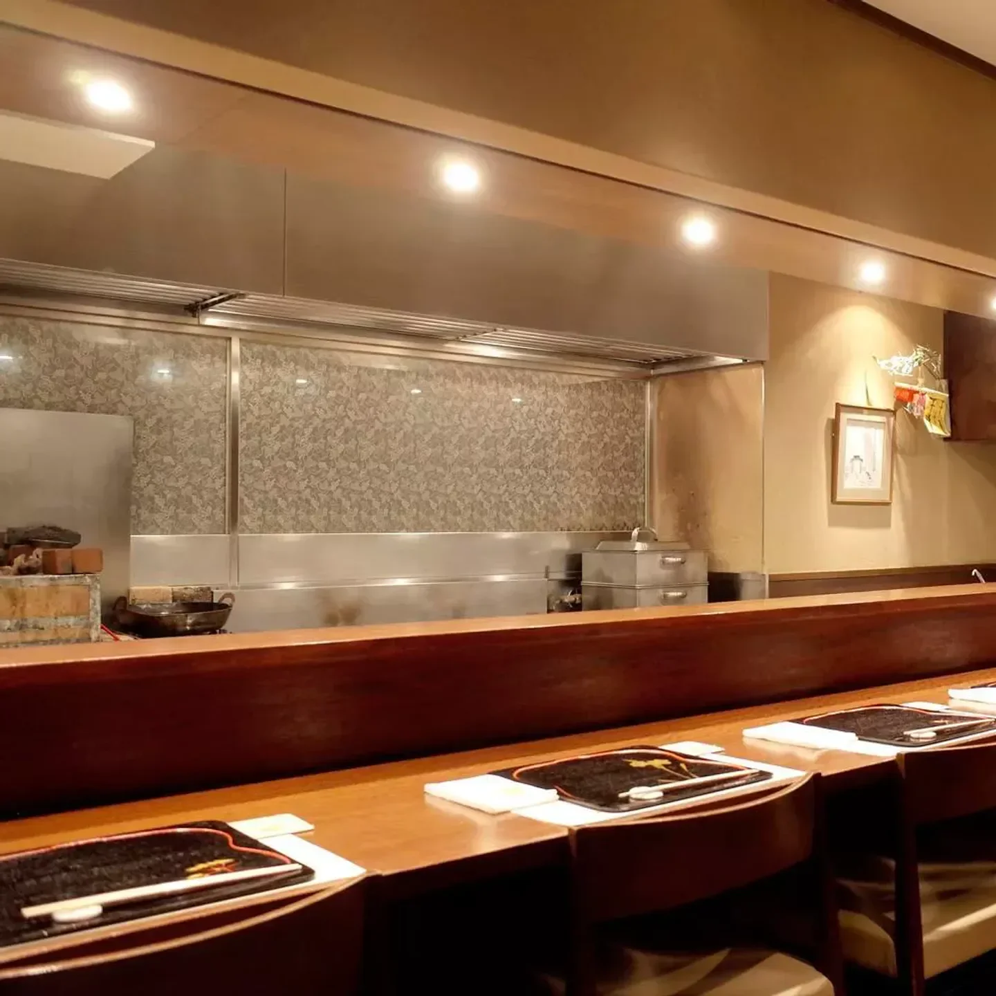 Interior view of Nishishinsaibashi Yuno restaurant in Osaka, showcasing the sushi bar.