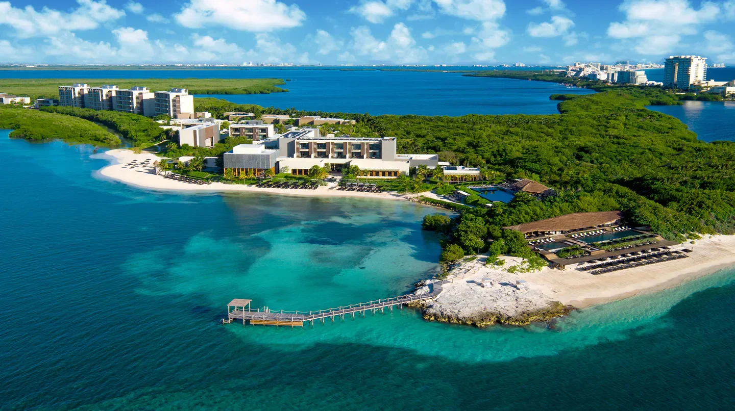Aerial view of Nizuc Resort & Spa in Cancun, showcasing the beach and turquoise waters.