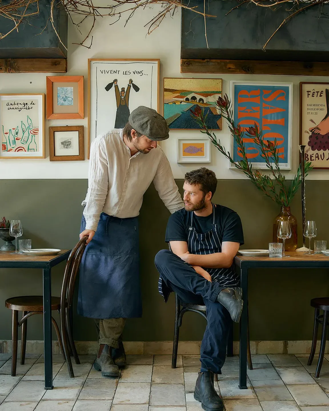 Two chefs in No. 7 Healesville restaurant, Yarra Valley, standing near tables and art