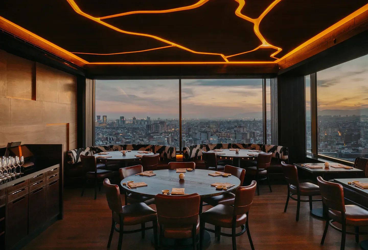 Nobu Barcelona restaurant interior with city views at sunset, elegant dining experience.