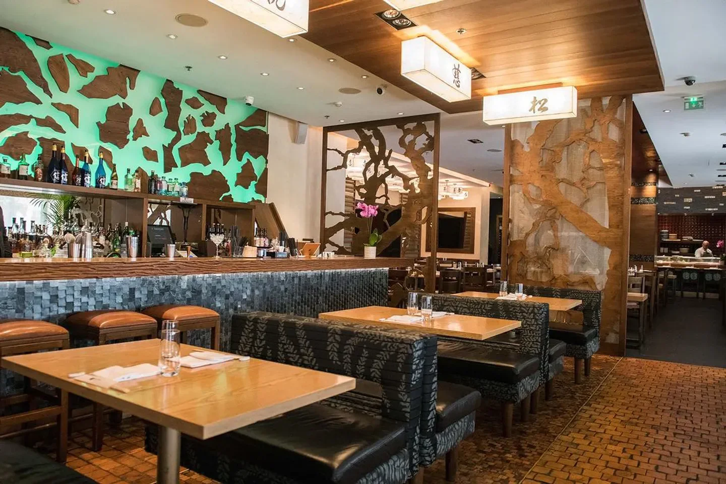 Interior of Nobu Budapest restaurant showcasing stylish decor and bar area with seating.