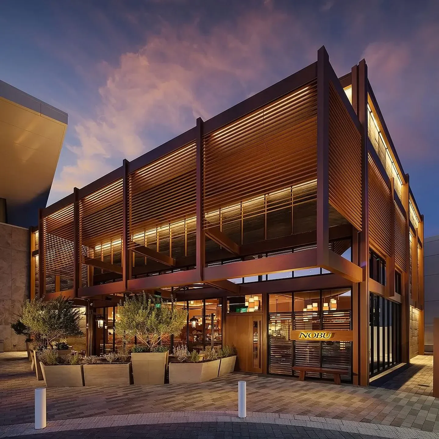 Exterior view of Nobu Sydney restaurant with modern architecture and ambient lighting at dusk