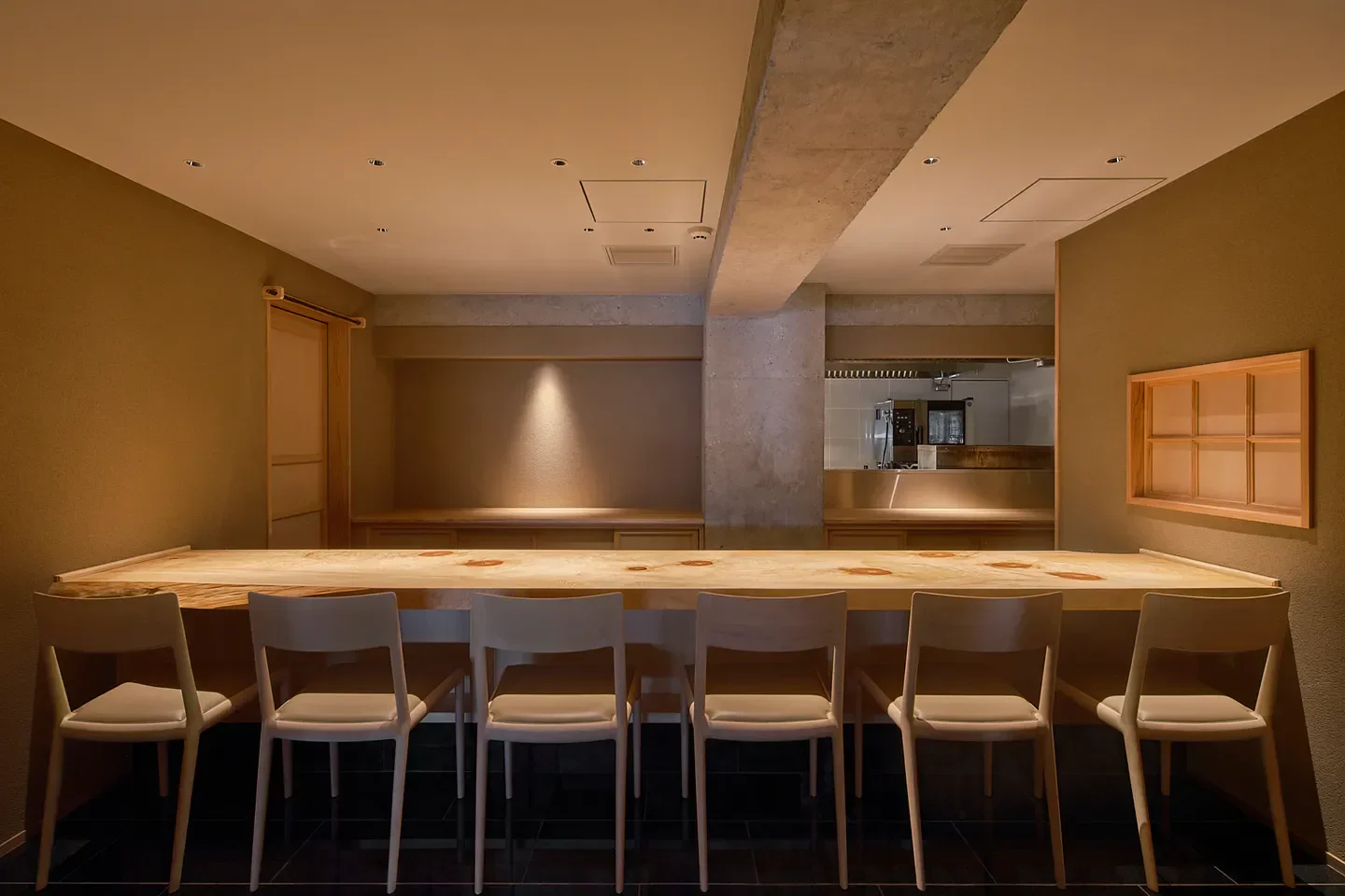 Interior of Nogizaka Shin restaurant in Tokyo with a long wooden table and chairs