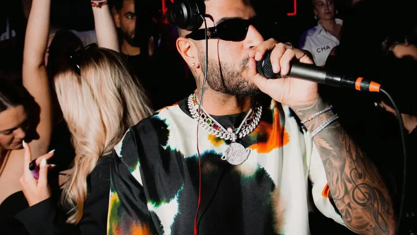 DJ performing at NOHO Club in Hamburg, surrounded by crowd enjoying the music.