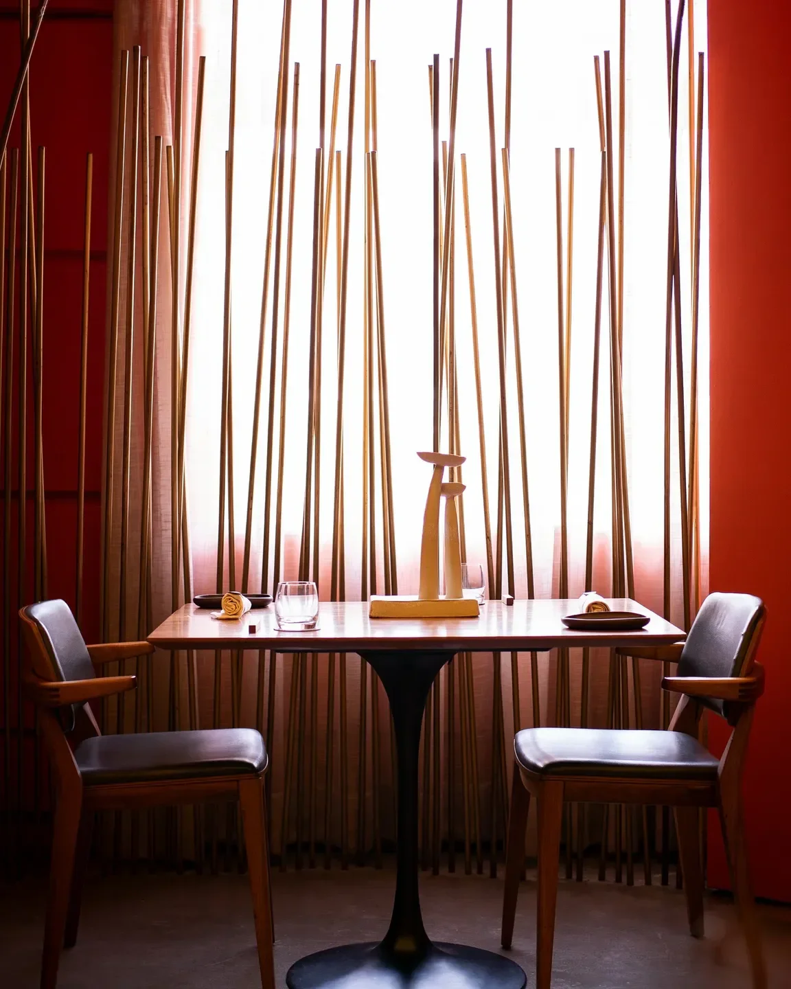 Cozy dining setting at Notiê restaurant in Sao Paulo with warm lighting and elegant decor.