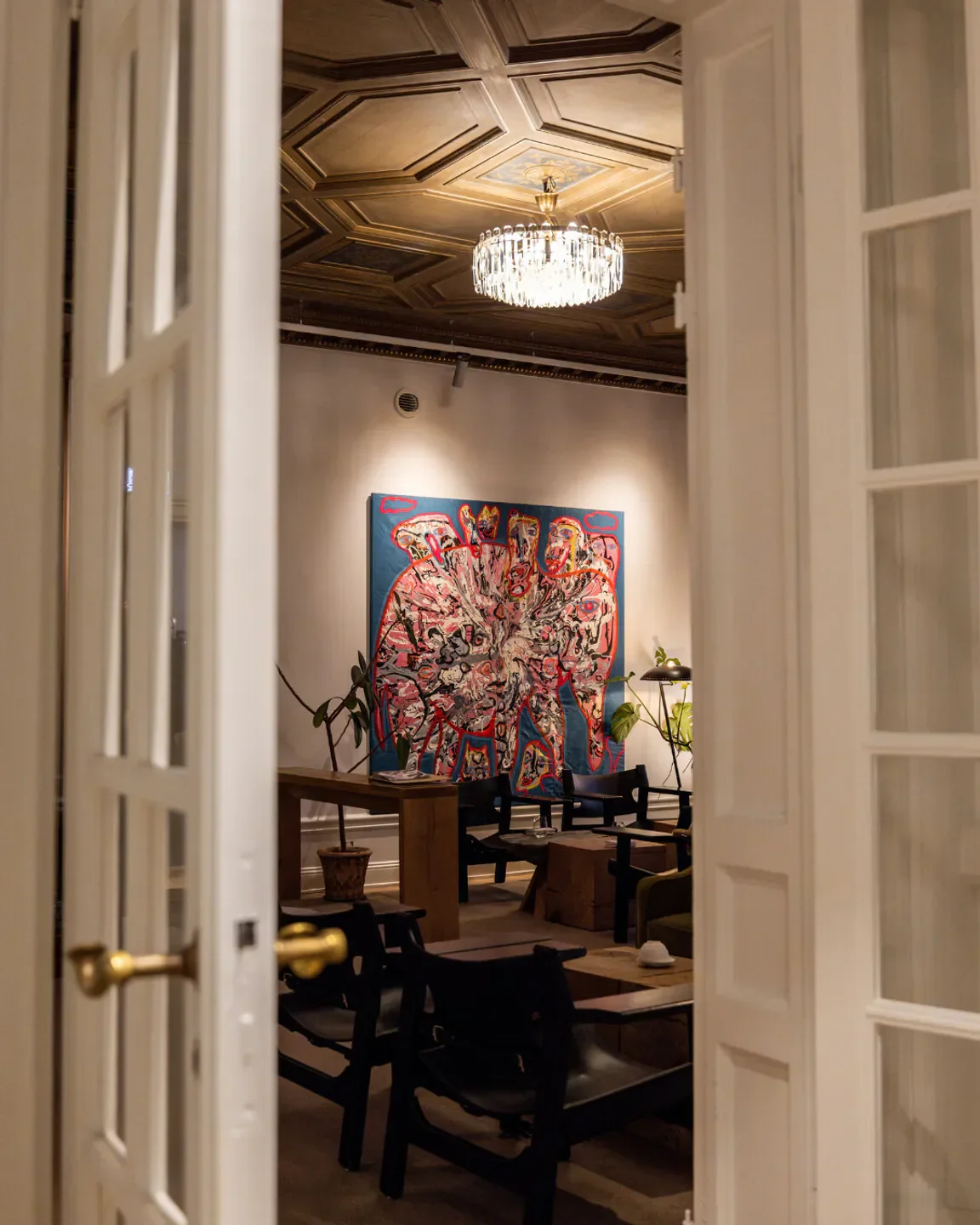 Interior view of Nour restaurant in Stockholm, featuring artwork and seating area.