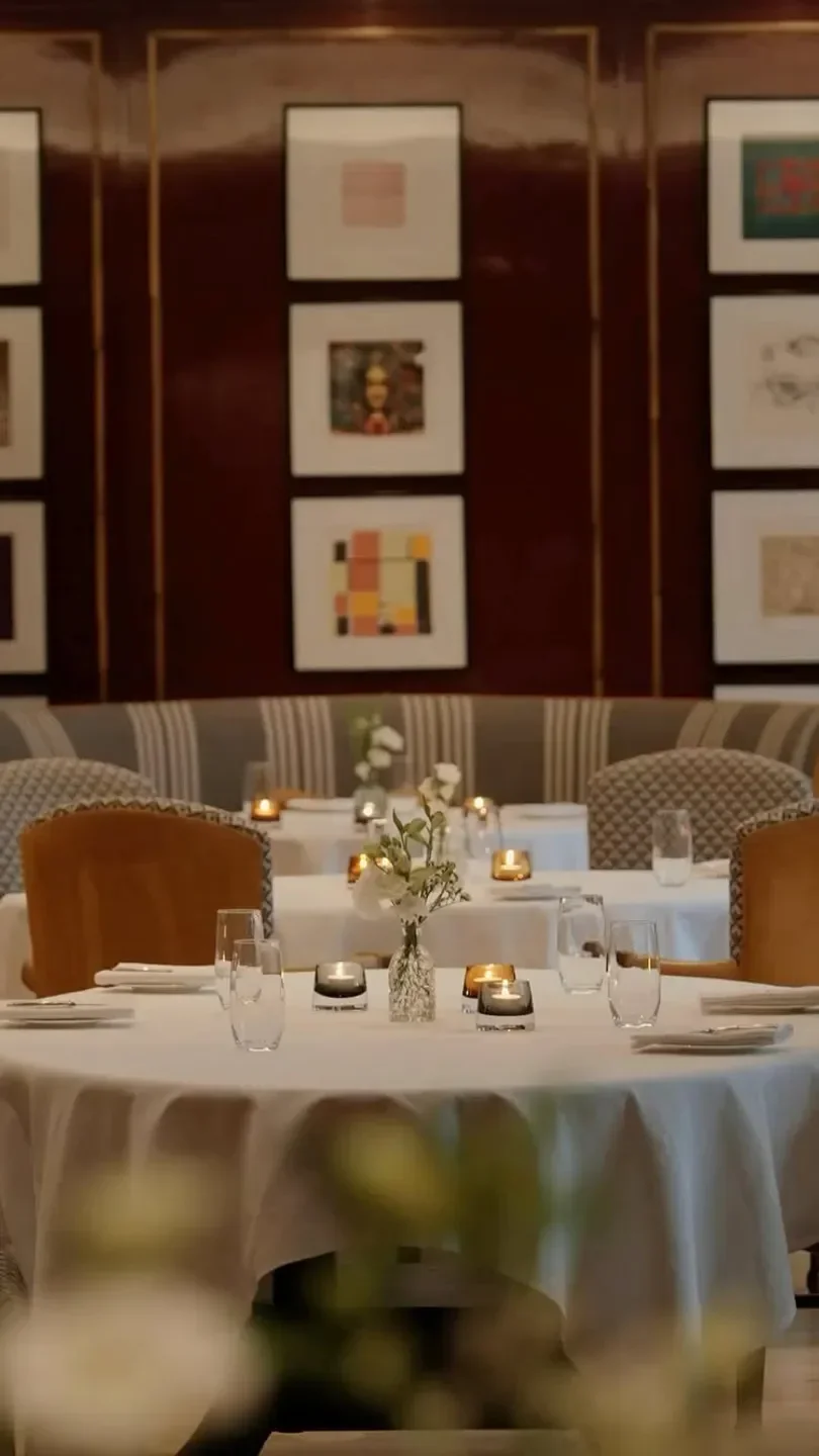 Cozy dining area in Number One restaurant, Edinburgh, with candles and flower arrangement.