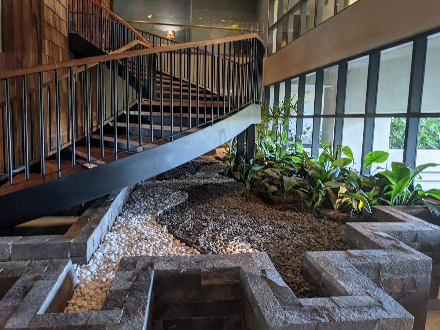 Interior of NUUP Spa Playa Mujeres in Riviera Maya with elegant staircase and plants.