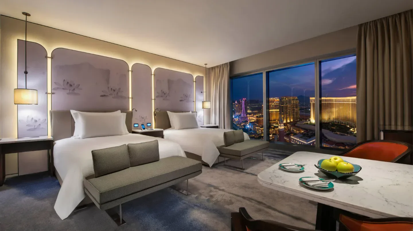Elegant hotel room at Nüwa Macau with city views over Macau at dusk