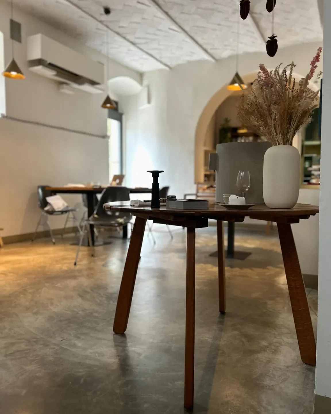 Interior of Octavin restaurant in Tuscany, featuring wooden table and decorative vase.