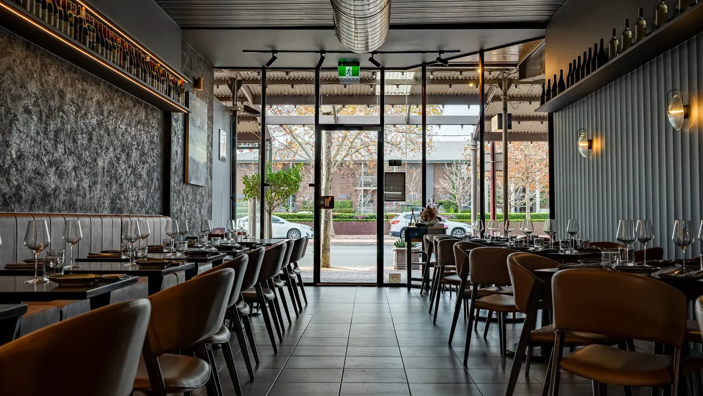 Interior of ODÉ Bistro in Adelaide, featuring tables, chairs, and an inviting atmosphere.