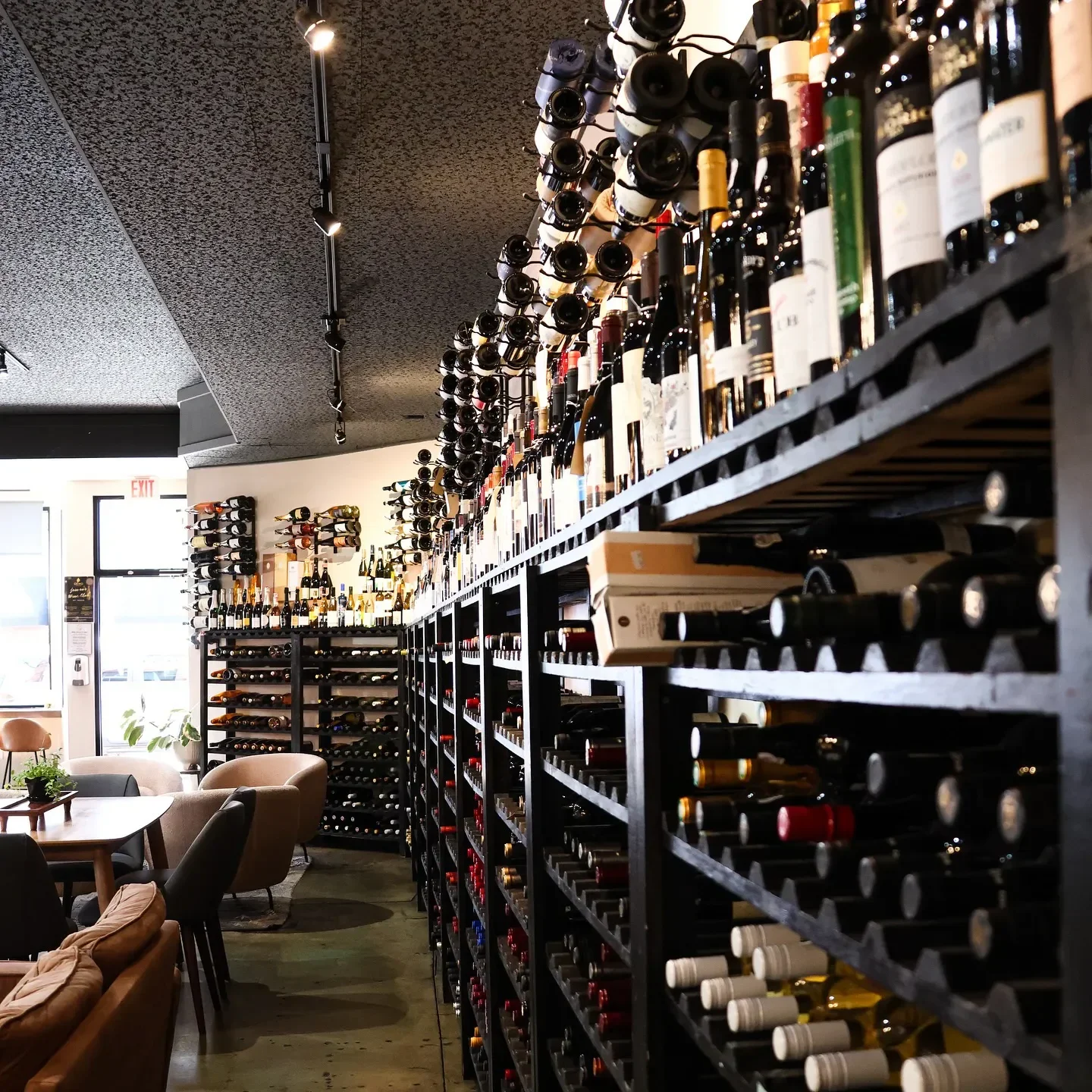 Wine collection at Oeno Wine Lounge in Flagstaff. Elegant restaurant interior, wine bottles on display.