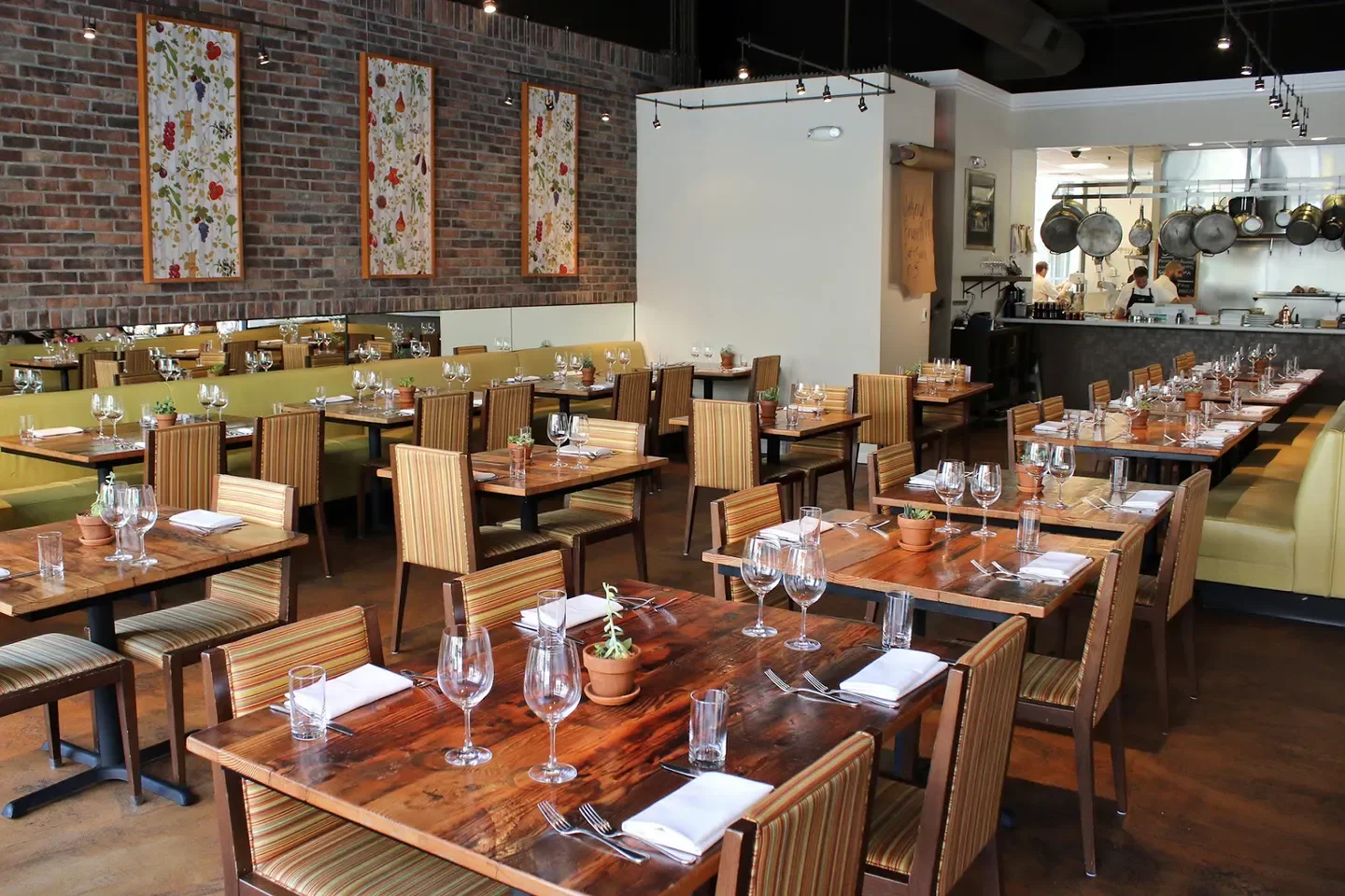 Interior dining at Oenotri, a popular restaurant in Napa Valley with rustic wood tables