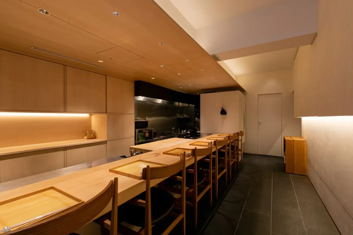 Interior of Oimatsu Hisano restaurant in Osaka, with wooden counter and seating.