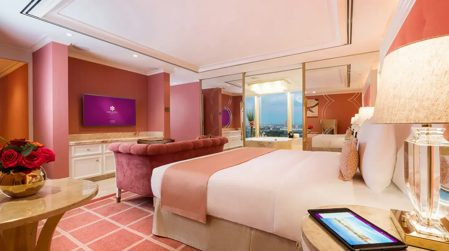 Luxury hotel room in Okada Manila, featuring a comfy bed and views of Manila.