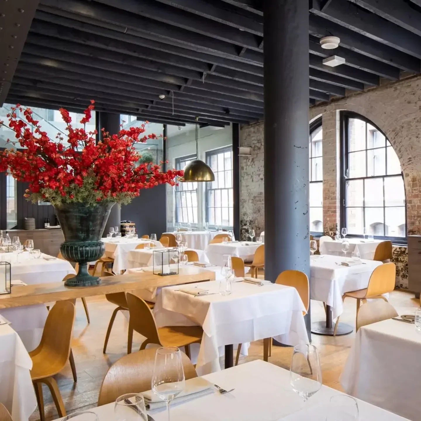 Elegant interior of Olio Kensington Street restaurant in Sydney, featuring floral decor and tables.