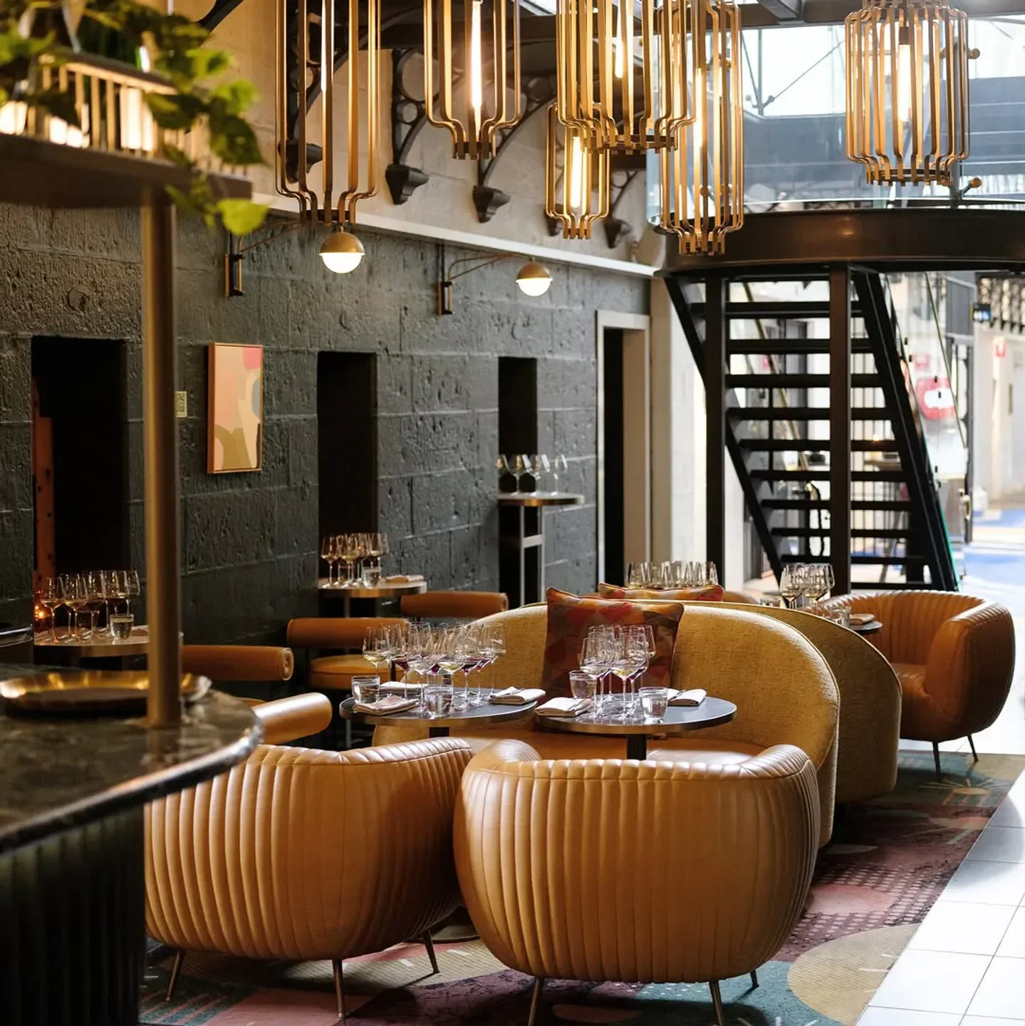 Interior of Olivine Wine Bar in Melbourne, featuring stylish seating and unique lighting.