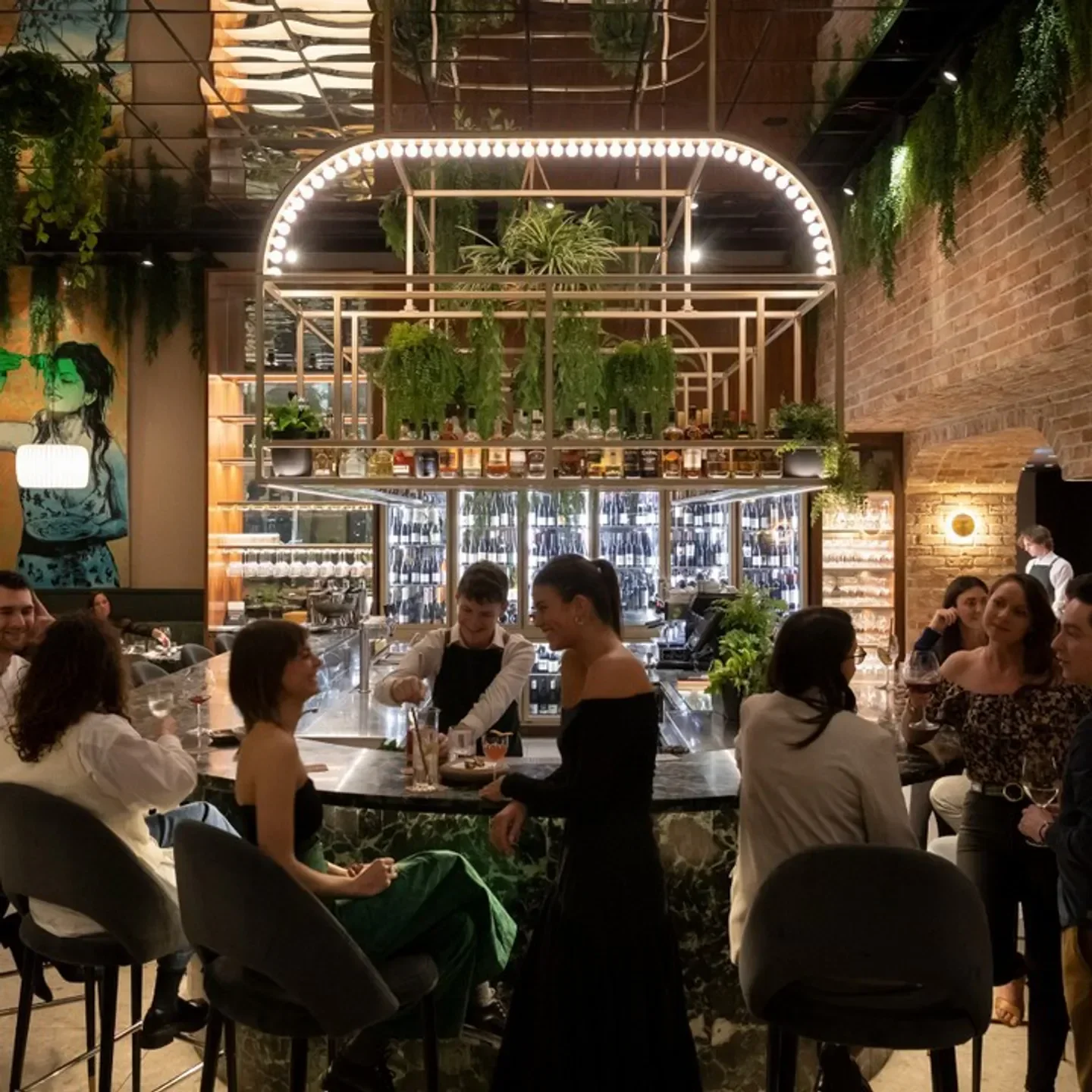 Omnia Bistro & Bar in Melbourne: Stylish interior with bar, cocktails, and people enjoying drinks.