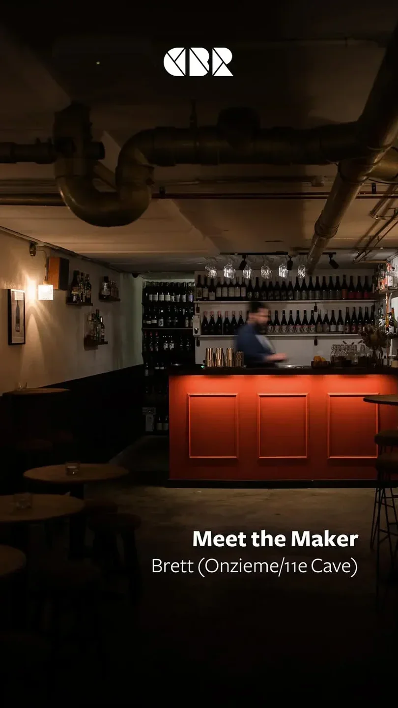 Interior shot of Onzieme restaurant in Canberra, showcasing bar and moody ambiance.
