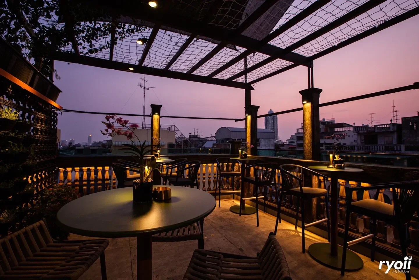 Rooftop dining at sunset in Opium Bar Bangkok, showcasing city views and elegant ambiance.