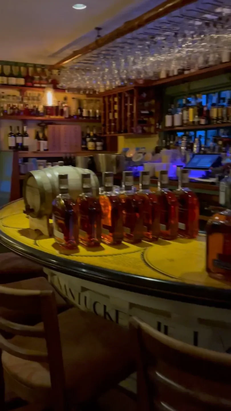 Interior of Oran Mor in Nantucket, featuring bar and bottles of alcohol.