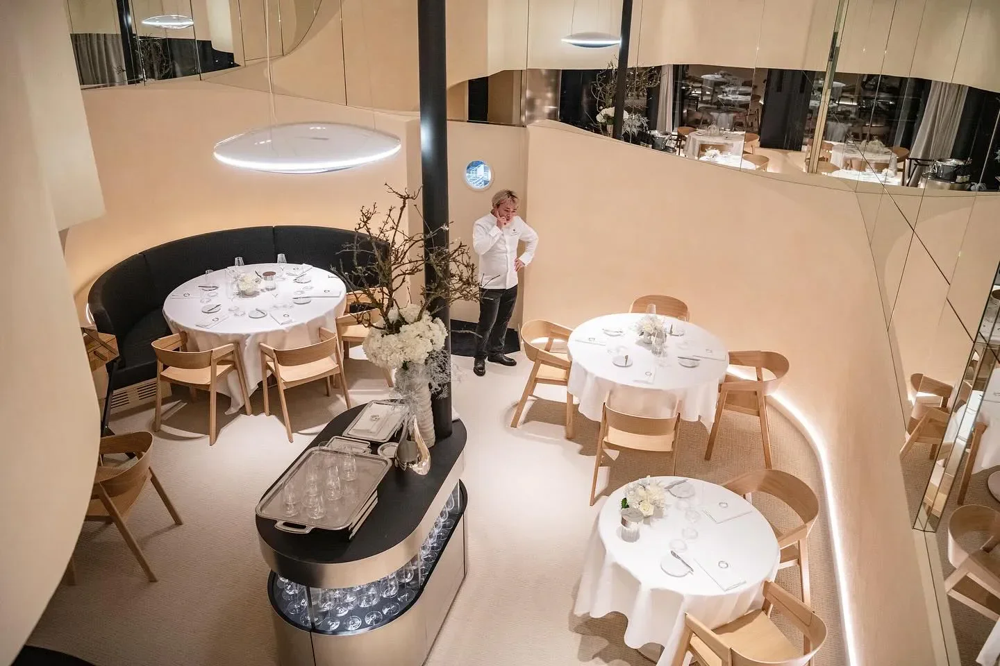 Elegant dining room interior at Ōrtensia restaurant in Paris with tables set.