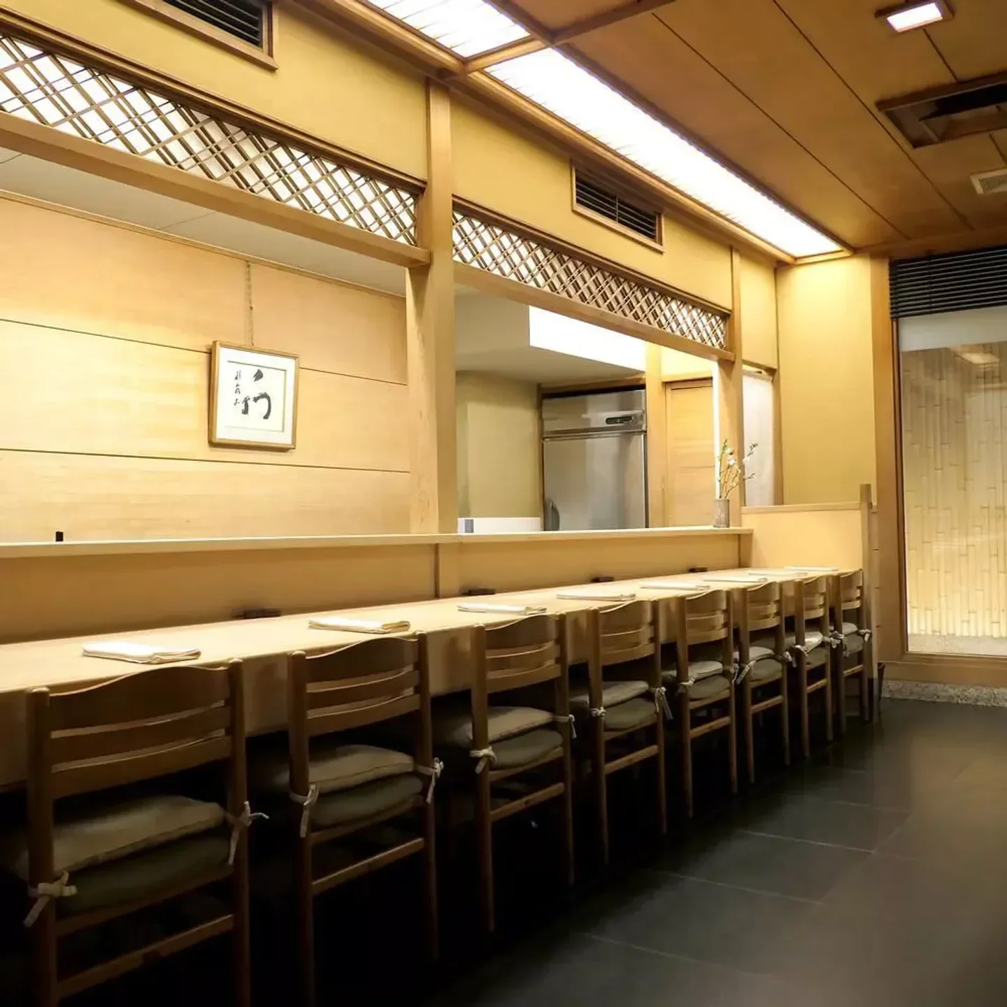 Interior of Oryori Mashita restaurant in Kyoto, with wooden tables and chairs.