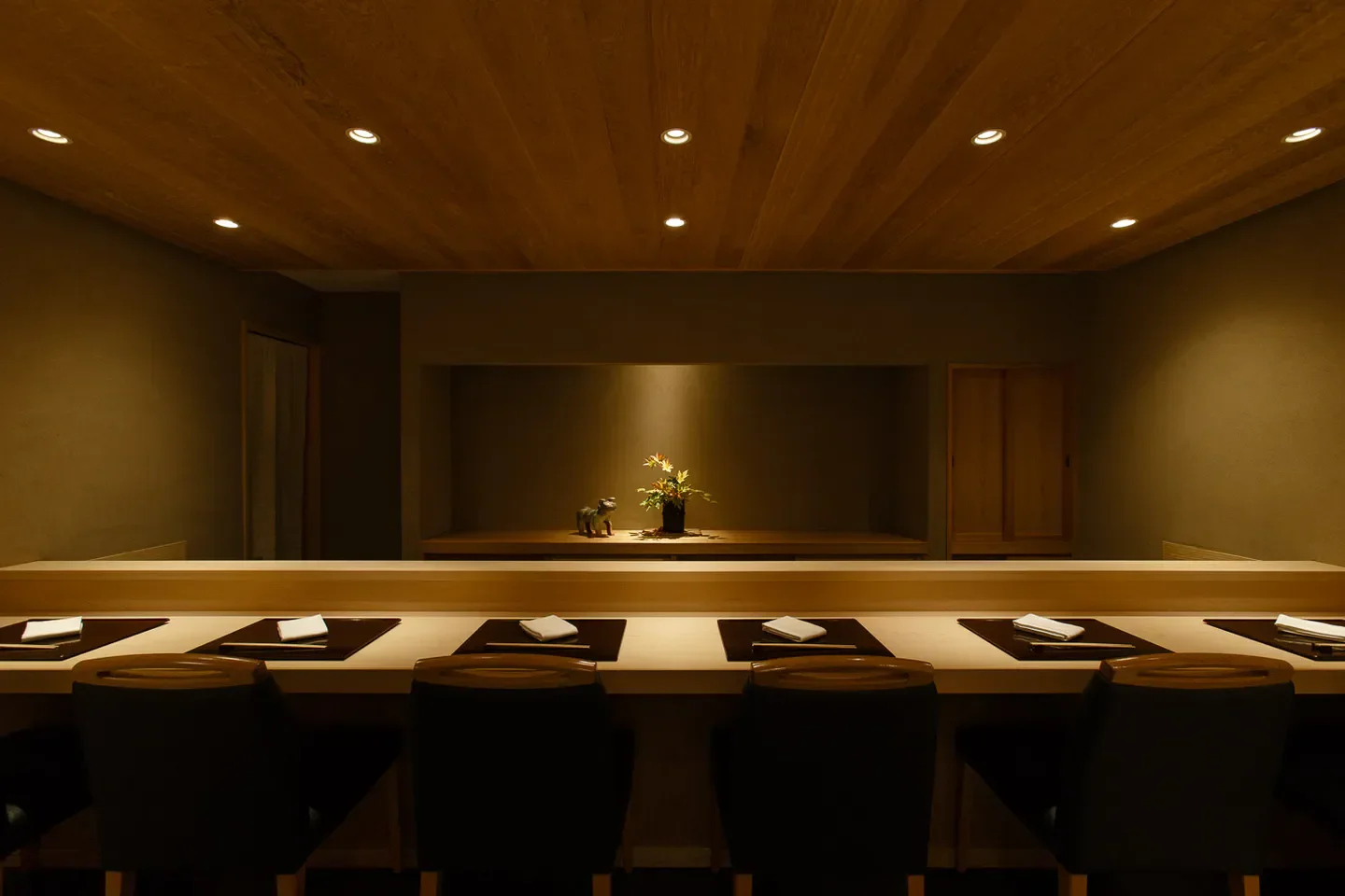 Interior of Oryori Tsuji in Tokyo, with seating, wooden accents, and decorative elements.