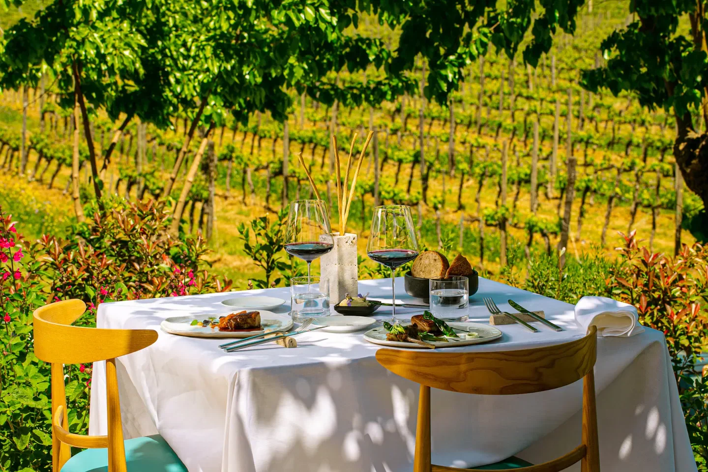 Osmosi restaurant in Tuscany, table set for dining with vineyard view