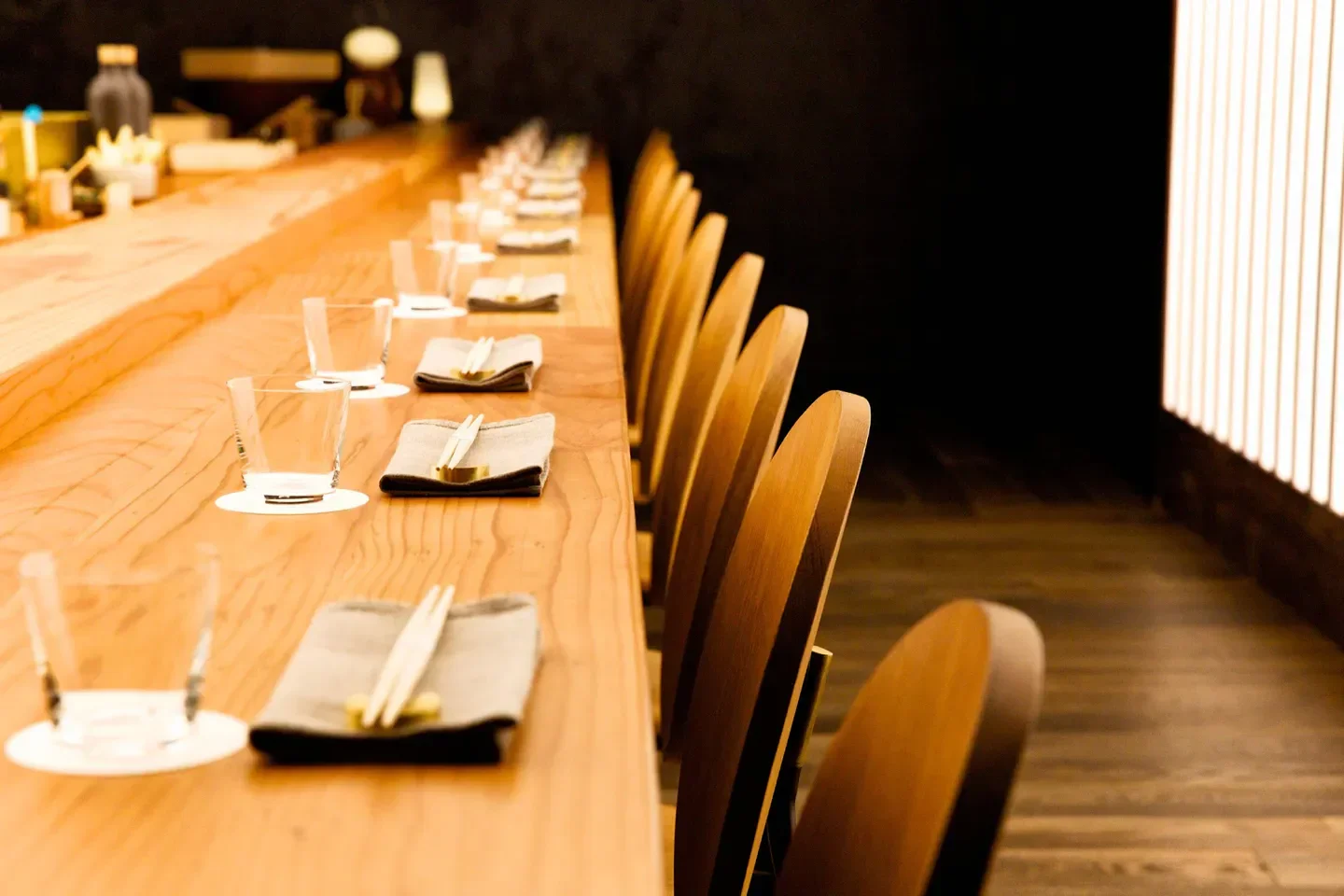 OTOKO in Austin: Stylish restaurant interior with wooden chairs and a long bar.
