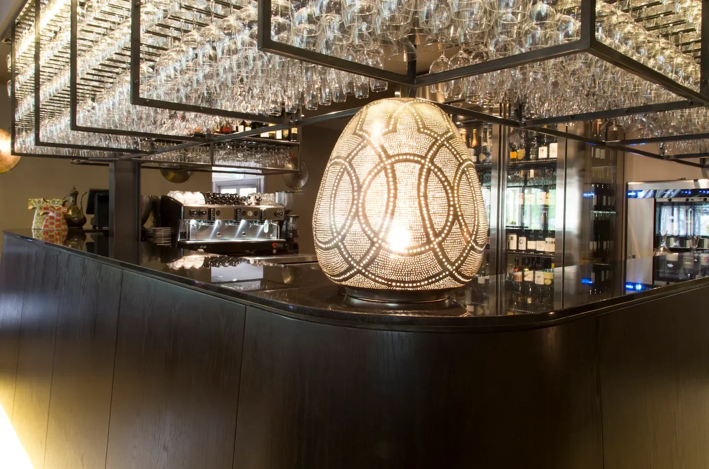 Interior bar at Ottoman Cuisine in Canberra with stylish lighting and elegant glasses.
